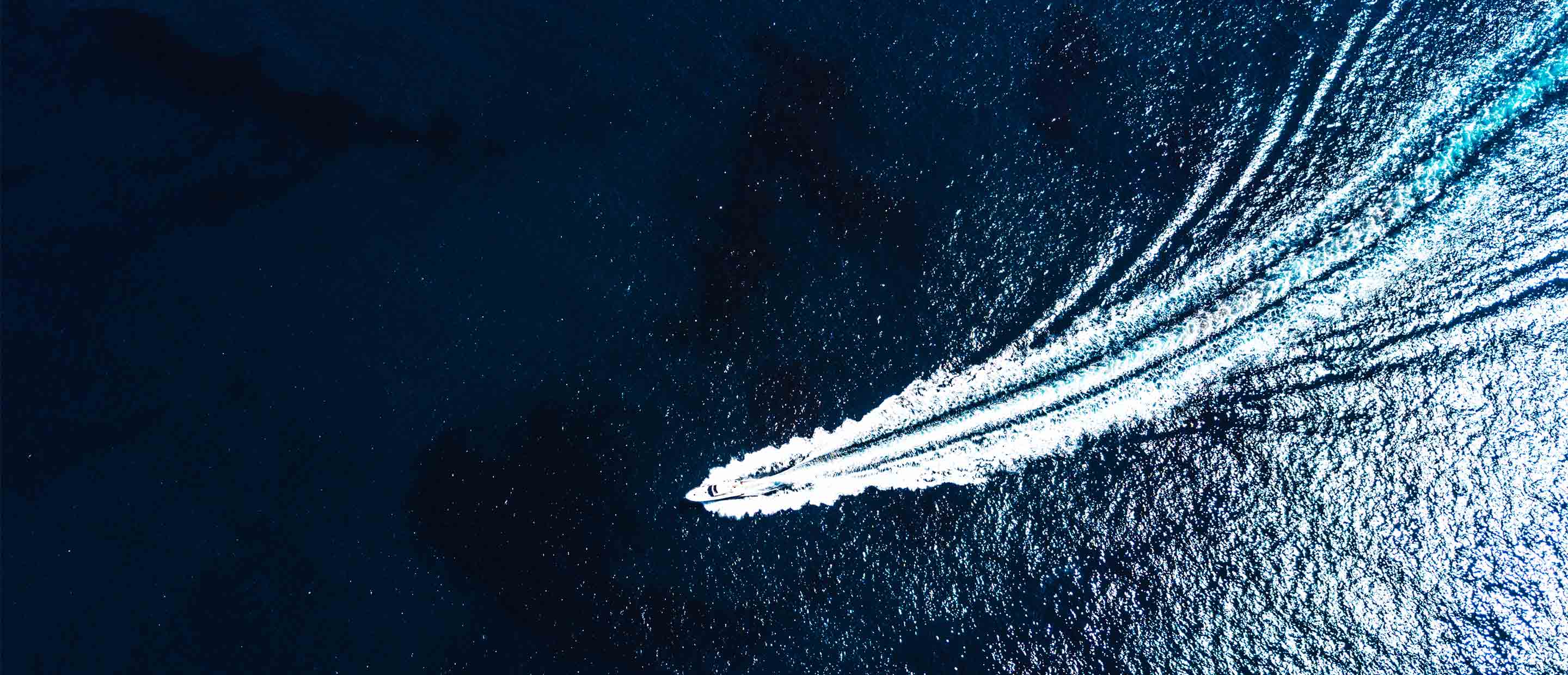 Sea Boat sealing in ocean view from above. Aerial view of moving boat or yacht in sea.